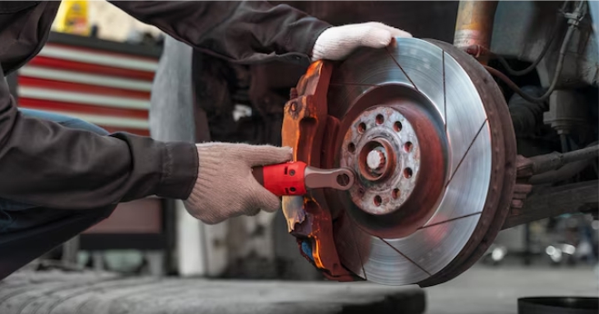 repairing a car brake disc with a wrench in an auto repair workshop in Marsden Park NSW